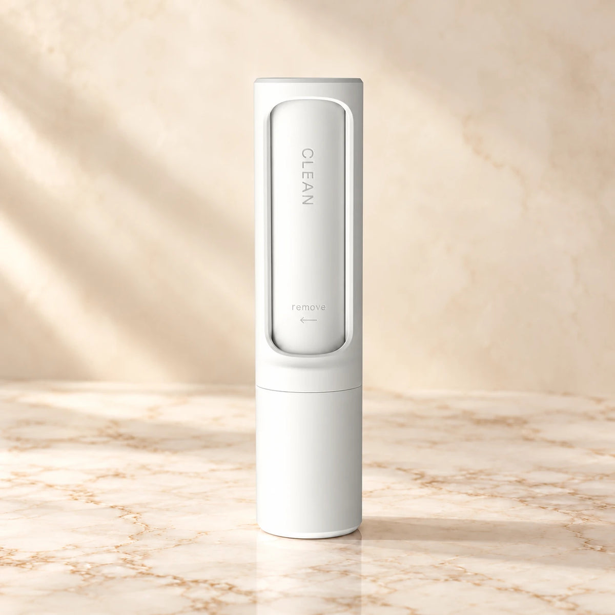 White reusable pet hair remover brush on an ivory marble surface